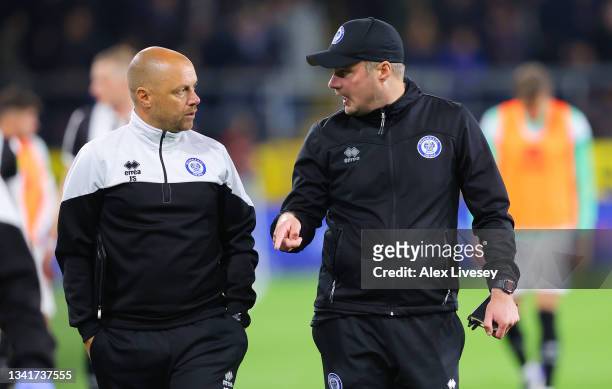 James Shan, Assistant Manager of Rochdale interacts with Robbie Stockdale, Manager of Rochdale during the Carabao Cup Third Round match between...