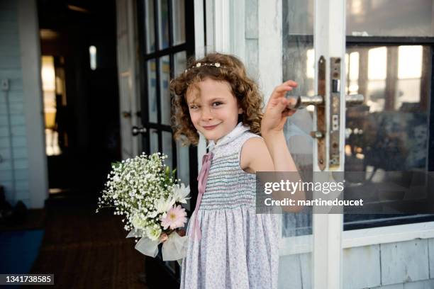 little girl getting out of beach house for small wedding. - small wedding ceremony stock pictures, royalty-free photos & images