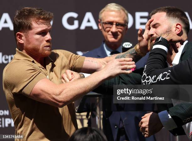 Canelo Alvarez slaps Caleb Plant during a face-off before a press conference ahead of their super middleweight fight on November 6 at The Beverly...