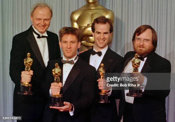 Academy Award Special Effect winners Dennis Muren, William George, Harley Jessup and Kenneth Smith celebrate backstage at the Academy Awards, April...