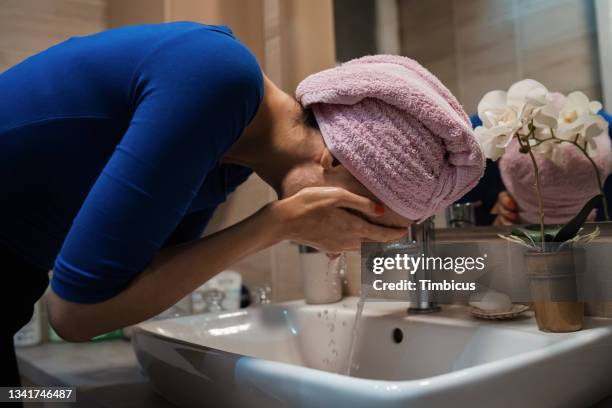 best way to remove make-up is to wash your face with make-up remover - bathroom routine stock pictures, royalty-free photos & images