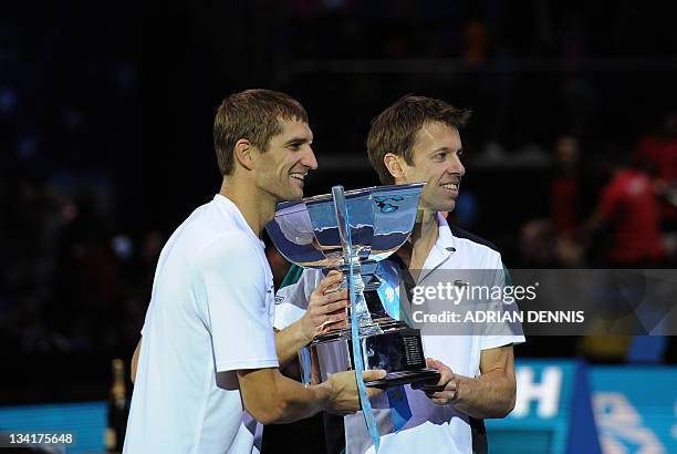 Daniel Nestor of Canada and partner Max Mirnyi of Belarus pose with the ATP World Tour Finals tennis tournament doubles champions' trophy after...