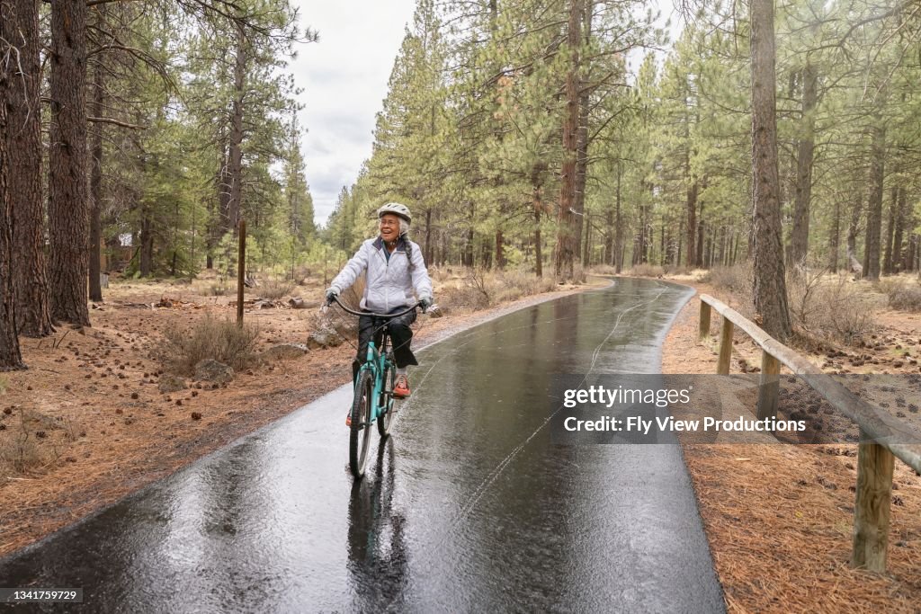 Mixed Riding Active Mixed Race Senior Woman On Relaxing Bike Ride High-Res Stock ...