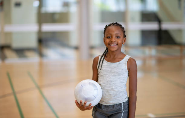 elementary student during gym class - girls volleyball stock pictures, royalty-free photos & images