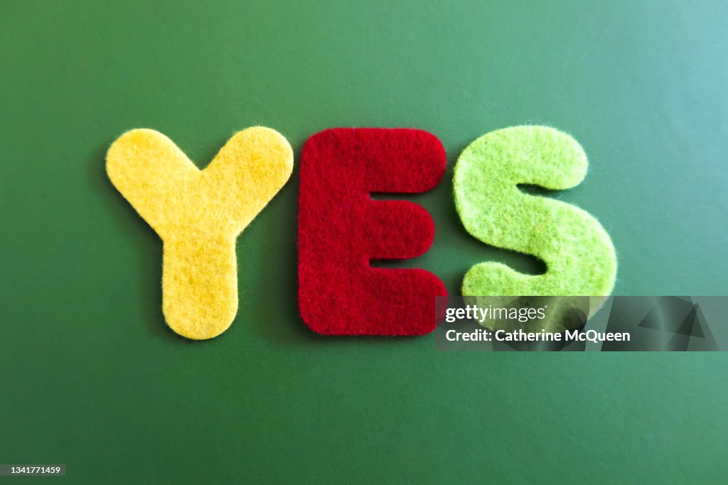 Variously colored felt alphabet letters spelling “yes”