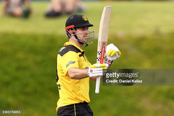 Mitchell Marsh of Western Australia raises his bat after reaching his half century during the Marsh One-Day Cup match between South Australia and...