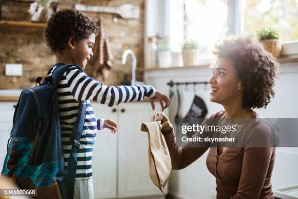 here's your lunch for school sweetie! - boy packlunch stock pictures, royalty-free photos & images