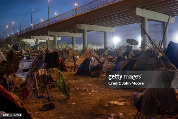 Boy bathes himself in a jug of water inside a migrant camp at the U.S.-Mexico border on September 21, 2021 in Del Rio, Texas. The immigrants, mostly...