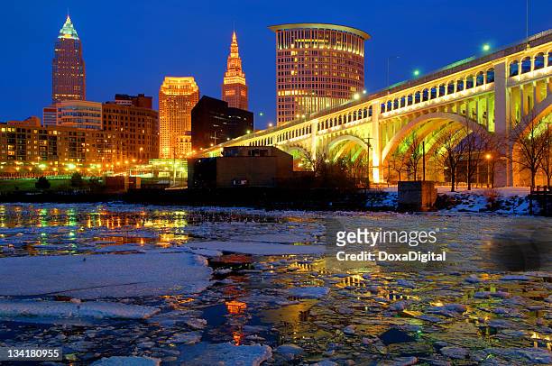 cleveland's downtown skyline on a winter night - cleveland ohio stock pictures, royalty-free photos & images