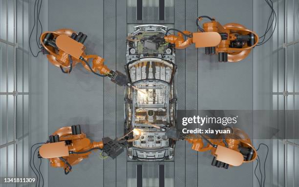 assembly line of robots welding car body - tillverka bildbanksfoton och bilder