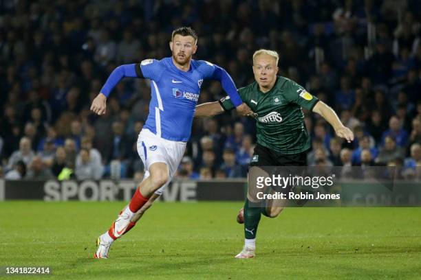 Ryan Tunnicliffe of Portsmouth FC and Ryan Broom of Plymouth Argyle race for the ball during the Sky Bet League One match between Portsmouth and...