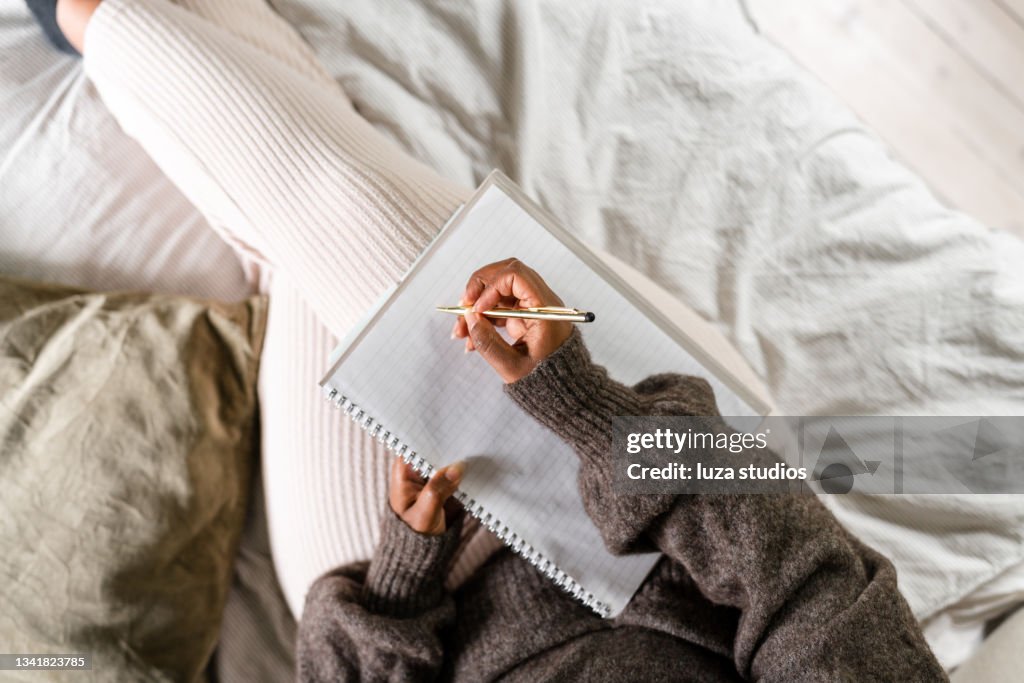 Woman writing in bed