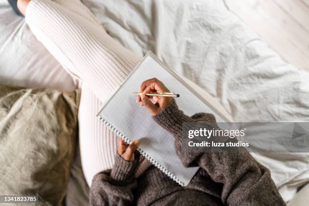 woman writing in bed - 日記 個照片及圖片檔