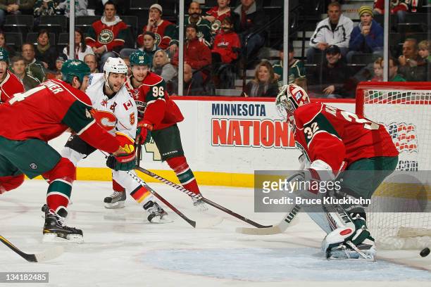 Mark Giordano of the Calgary Flames scores a goal against goaltender Nicklas Backstrom of the Minnesota Wild during the game at the Xcel Energy...