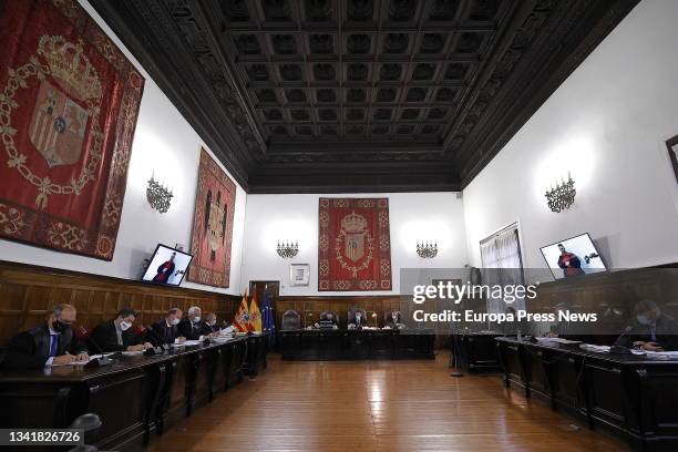 Norbert Feher, alias 'Igor the Russian', is seen on a screen as he attends a hearing on his triple crime committed in Andorra, at the High Court of...