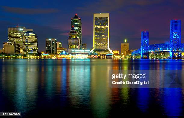 jacksonville cityscape reflecting off the water - jacksonville florida stock pictures, royalty-free photos & images