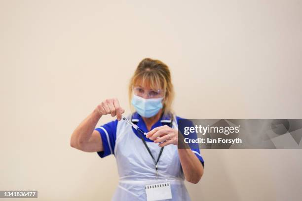 Member of the medical team draws up the Pfizer-BioNTech COVID-19 Vaccine at the Excelsior Academy on September 22, 2021 in Newcastle upon Tyne,...