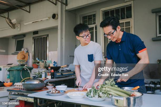 asian chinese father son cooking at wet kitchen backyard of house during weekend preparing dinner for family - asian family cooking stock pictures, royalty-free photos & images