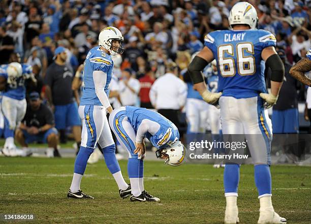 Nick Novak of the San Diego Chargers reacts after missing a 51 yard field goal for the win with Mike Scifres and Jeromey Clary during overtime...