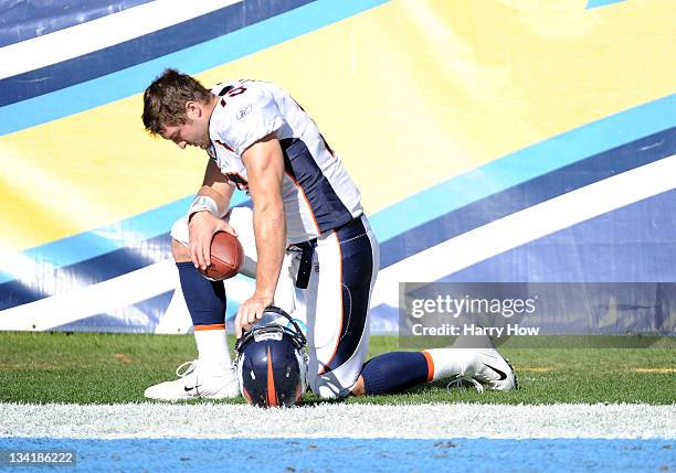 Tim Tebow of the Denver Broncos prays before the game against the San Diego Chargers at Qualcomm Stadium on November 27, 2011 in San Diego,...