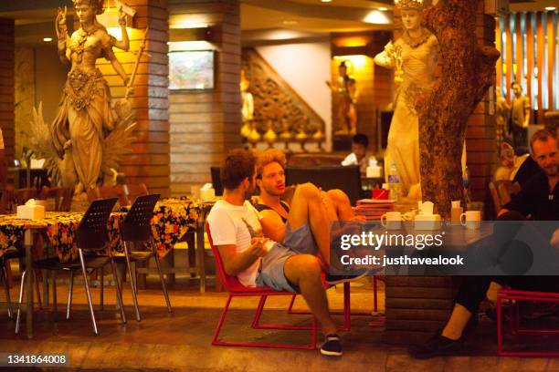 relaxed sitting two caucasian backpacker tourists are sitting at restaurant in khao san road - khao san road bildbanksfoton och bilder