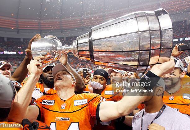 Game MVP Travis Lulay of the BC Lions hoists the Grey Cup after B.C. Beat the Winnipeg Blue Bombers 34-23 to win the CFL 99th Grey Cup November 27,...