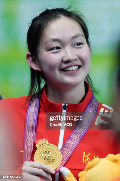 Gold medalist Li Bingjie of Hebei celebrates on the podium after the Women's 1,500m Freestyle Final during China's 14th National Games at Xi'an...