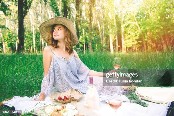 woman having picnic in summer park - woman picnic dress stock pictures, royalty-free photos & images