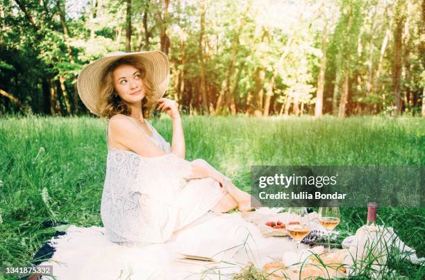 woman having picnic in summer park - woman picnic dress stock pictures, royalty-free photos & images
