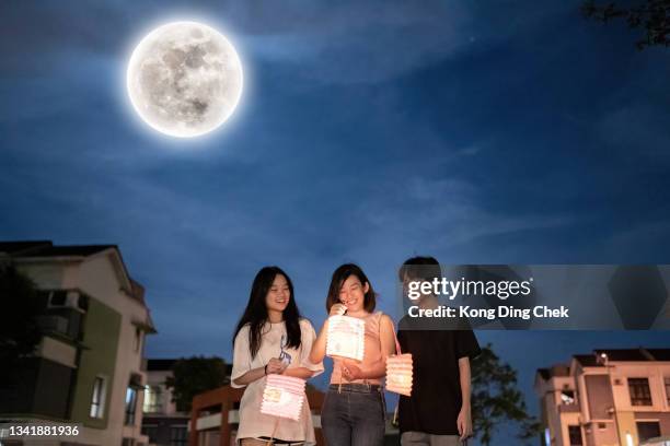 asian chinese mother with children holding paper lantern, celebration mid autumn festival. - chinese lantern night stock pictures, royalty-free photos & images