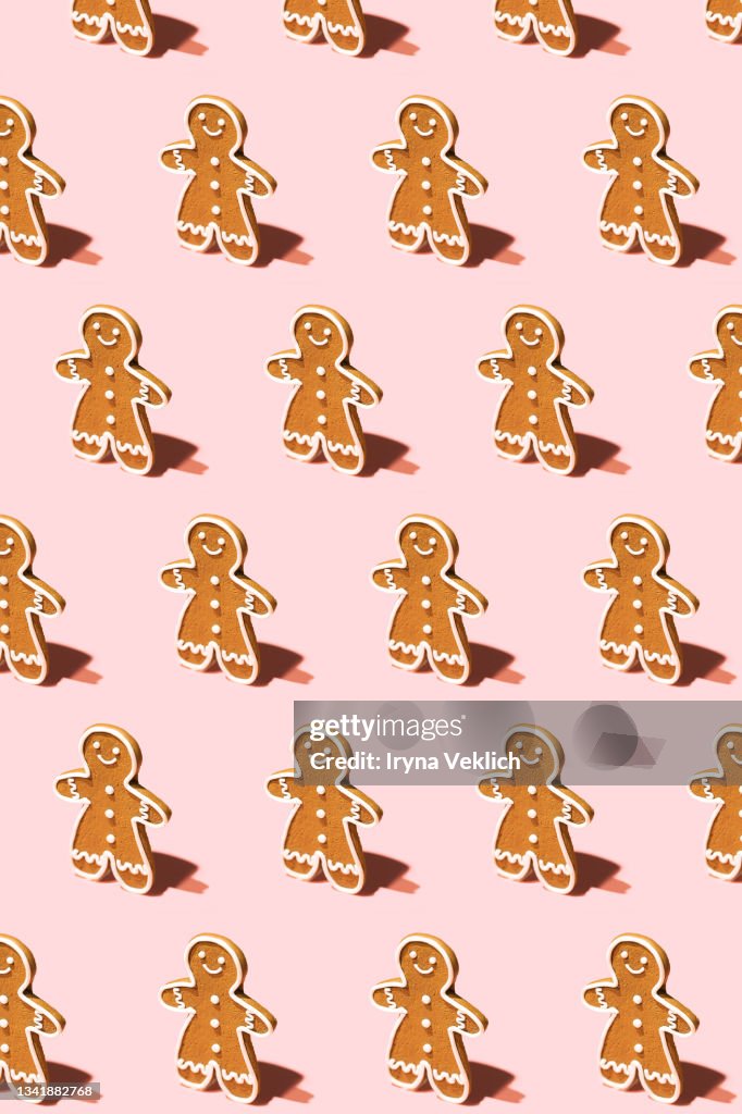 Pattern made of Gingerbread Man on Pastel Pink Background.