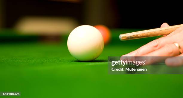 pool player with cue poised to hit cue ball - snooker stock pictures, royalty-free photos & images