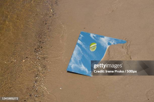 high angle view of paper on sand at beach - irene beach stock pictures, royalty-free photos & images