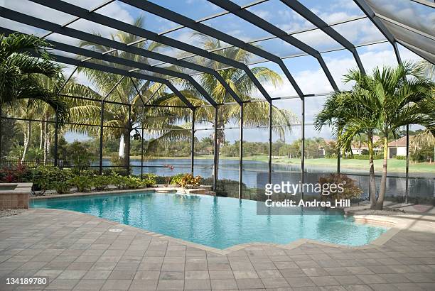 backyard pool with window panel and ceiling next to lake - landscaped patio stock pictures, royalty-free photos & images