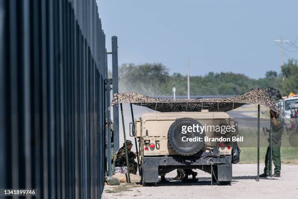 Border Patrol agents and members of the National Guard rest outside of a checkpoint entry near the Del Rio International Bridge on September 22, 2021...