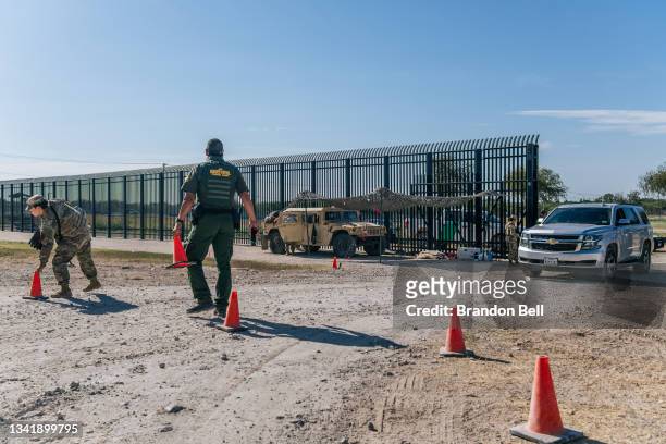 Border Patrol agents and members of the National Guard patrol a checkpoint entry near the Del Rio International Bridge on September 22, 2021 in Del...
