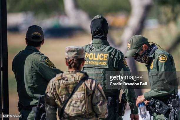 Border Patrol agents and members of the National Guard patrol a checkpoint entry near the Del Rio International Bridge on September 22, 2021 in Del...