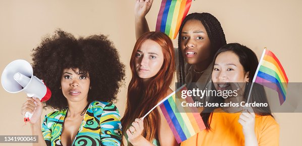 Group of multiracial women, with lgbt gay pride flag Group of multiracial women, with lgbt gay pride flag