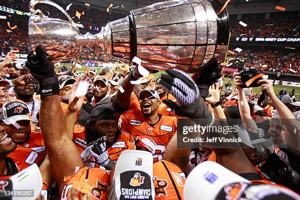 Lions' players celebrate with the Grey Cup Grey Cup after beating the Winnipeg Blue Bombers 34-23 to win the CFL 99th Grey Cup November 27, 2011 at...