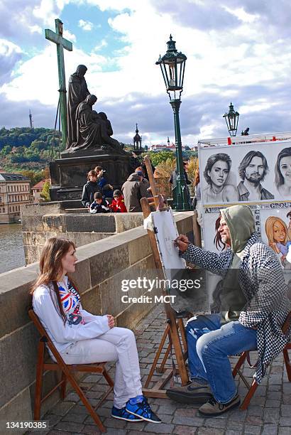 An artist sketches along the Charles Bridge in Prague.