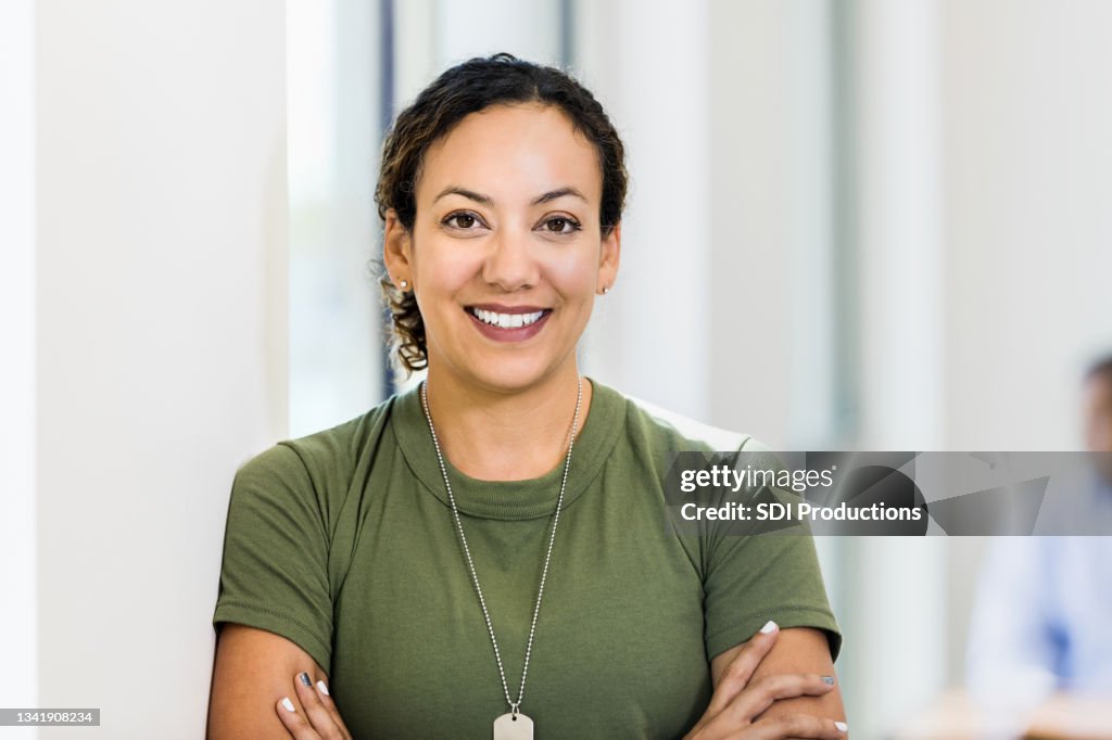 Photo of smiling female soldier taking break