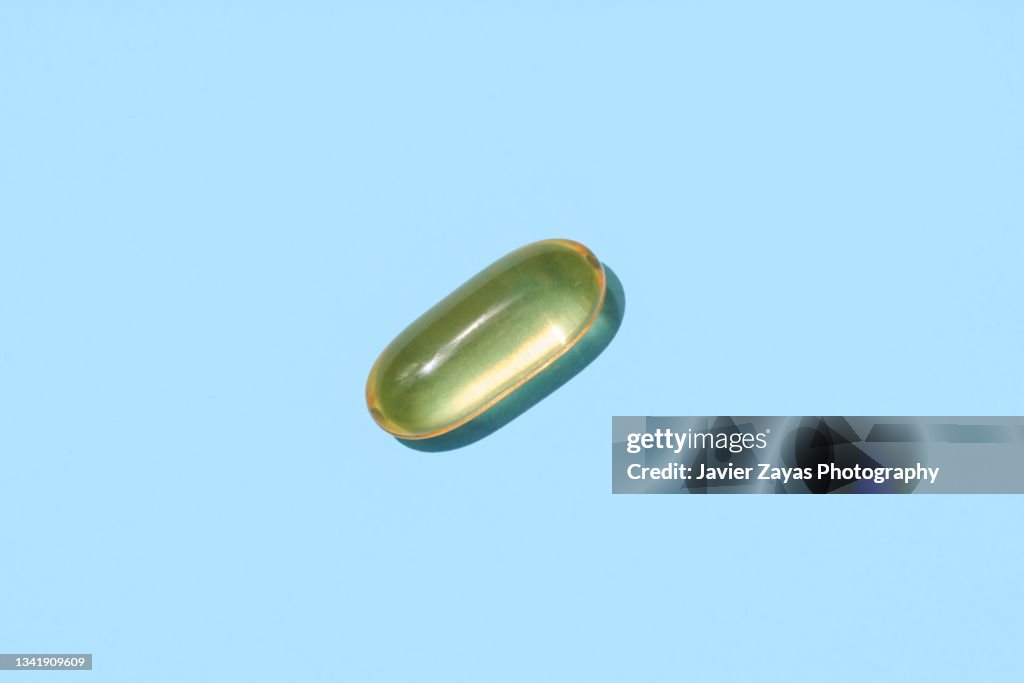 Omega-3 Fatty Acids Pill On Blue Background