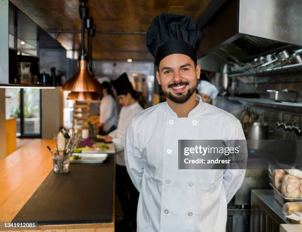 portrait of a happy chef working at a restaurant - happy chef stock pictures, royalty-free photos & images