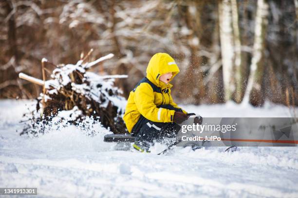 children riding on snowmobile during winter holidays - snow vehicle stock pictures, royalty-free photos & images