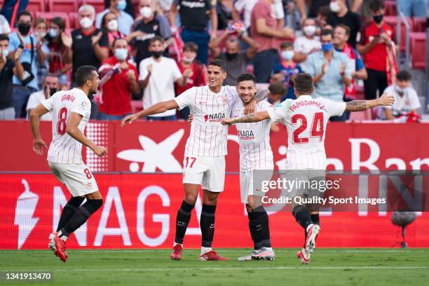 Players of Sevilla FC celebrate his team's second goal during the La Liga Santander match between Sevilla FC and Valencia CF at Estadio Ramon Sanchez...