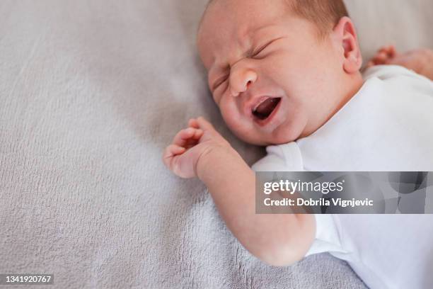 newborn baby crying - cramp stock pictures, royalty-free photos & images