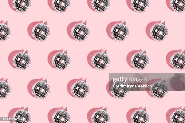 disco ball and baubles on pastel pink background. - swing dancing stockfoto's en -beelden