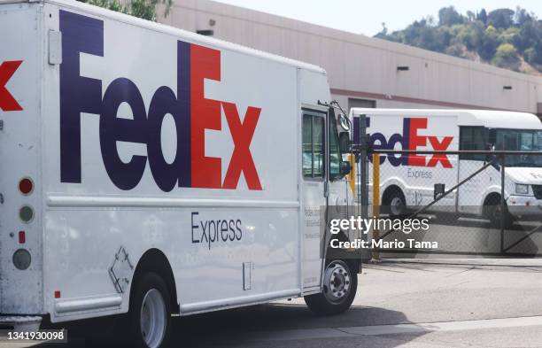 FedEx trucks are parked at a FedEx Ship Center on September 22, 2021 in Los Angeles, California. FedEx plans to increase shipping rates in 2022 with...