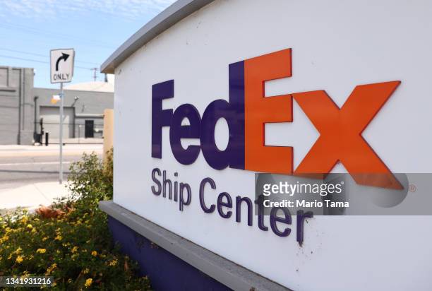 The FedEx logo is displayed at a FedEx Ship Center on September 22, 2021 in Los Angeles, California. FedEx plans to increase shipping rates in 2022...