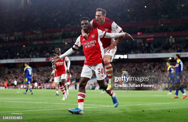 Eddie Nketiah celebrates with teammate Cedric Soares of Arsenal after scoring their team's third goal during the Carabao Cup Third Round match...